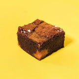 Salted Caramel Brownie with fudgy base, crispy top, scratch-made caramel swirls, and a sprinkle of sea salt by Crumbs & Doilies